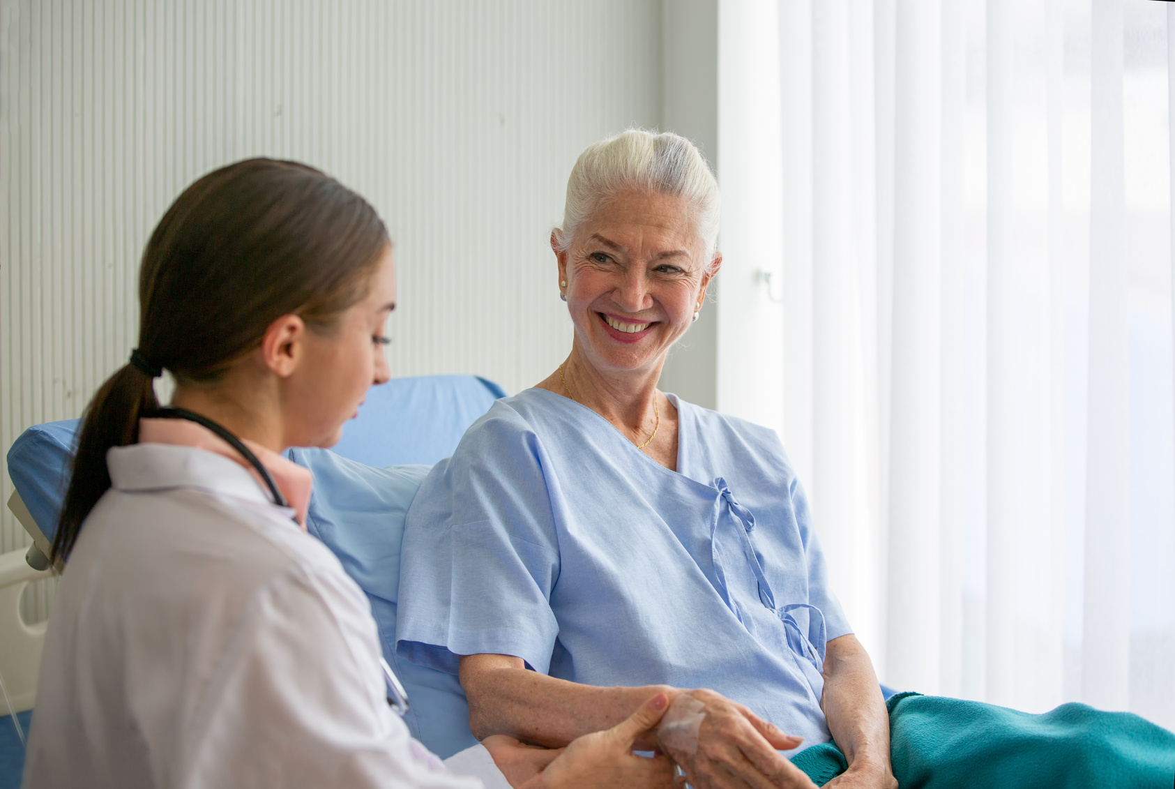 Elderly Woman on a Hospital Bed Being Checked By Doctor